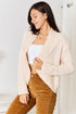 Angled front view of cream open-front cardigan with long sleeves