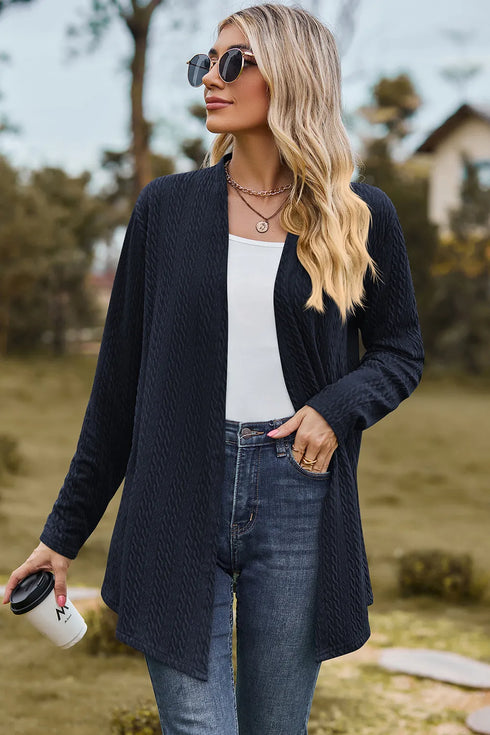 Dark blue textured open-front cardigan worn with sunglasses
