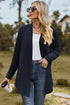 Dark blue textured open-front cardigan worn with sunglasses