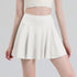 White pleated tennis skort front view on model