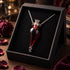 Glass blood-red vial pendant necklace with crown-style silver-tone detail; display box not included