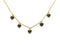 Gold-tone layering necklace with small black heart charms arranged on white