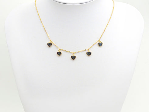 Black heart charm necklace displayed on a white bust for scale
