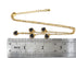 Black heart necklace beside a ruler, showing the extension chain and clasp