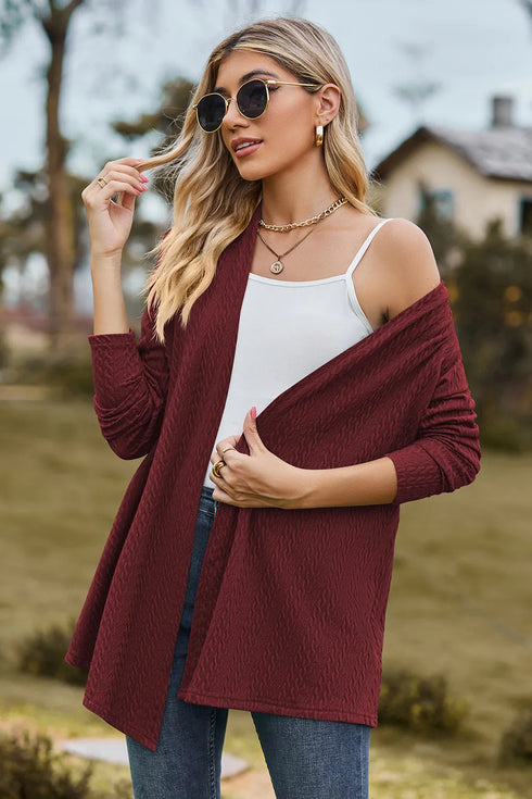 Burgundy cardigan worn off one shoulder showing textured fabric