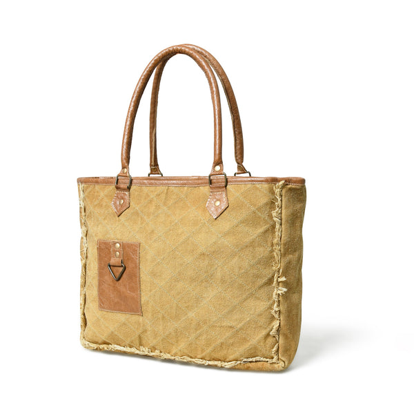 Beige canvas tote with brown leather handles and fringe, angled front view