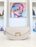 Beige Fame crescent crossbody purse, front view