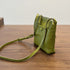 Side view of green RockCow T25017 bag showing its slim profile and adjustable strap