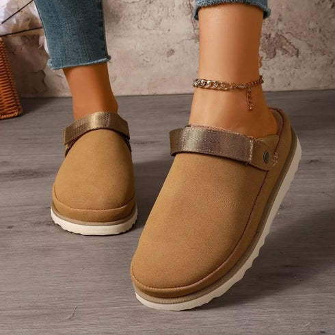 Brown round-toe clogs worn on a model, front view