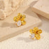 Flower stud earrings showing sculpted petals and clear accents