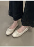 Beige bow ballet flats worn with wide-leg dark denim