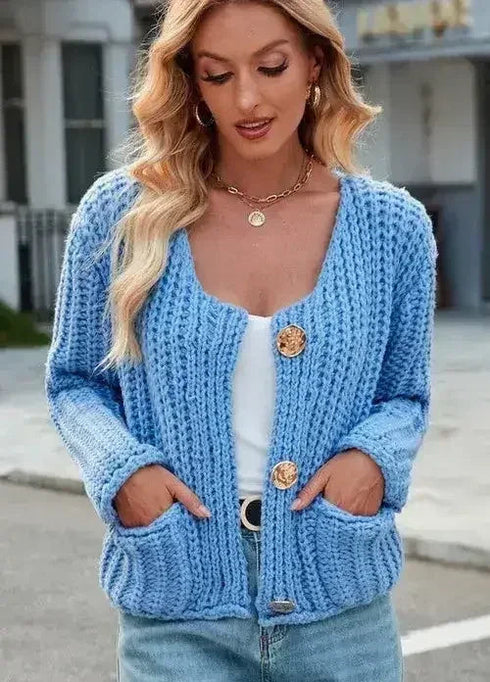 Blue button-front cardigan showing the cropped hem and patch pockets
