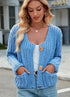 Blue button-front cardigan showing the cropped hem and patch pockets