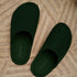 Forest Green Fulton house shoes arranged toe-to-heel on a pale rug