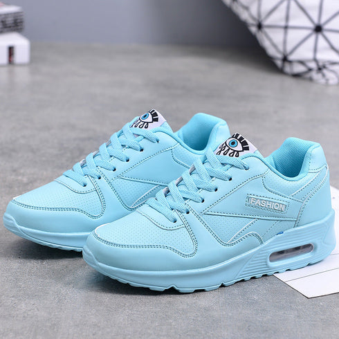 Blue lace-up platform sneakers showing raised soles and side panels