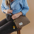 Hopper canvas crossbody worn with a blue shirt and dark denim