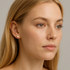 White pearl stud earring worn on an ear
