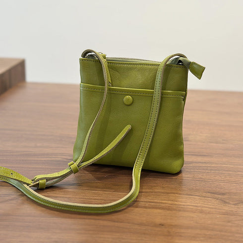 Green RockCow leather phone crossbody at an angle with its shoulder strap