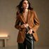 Camel suede-look blazer worn open with black trousers
