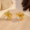 Pair of gold-tone flower stud earrings with clear stone accents