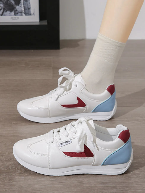 White sneakers with red side accents and light-blue heel panels