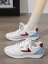White sneakers with red side accents and light-blue heel panels