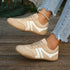 Side view of beige lace-up sneakers with white panels