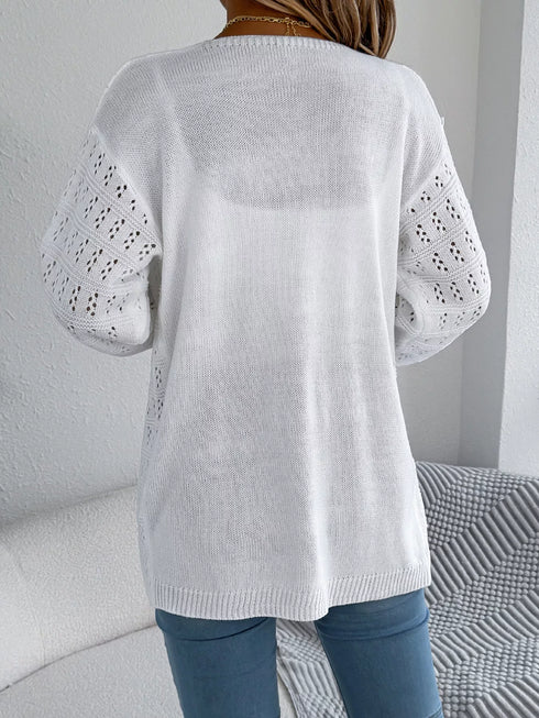 White crochet-knit cardigan, back view showing the longer hem