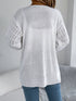 White crochet-knit cardigan, back view showing the longer hem