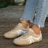 Beige contrast-panel sneakers showing flat tan-colored soles