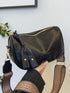 Black retro crossbody bag held in a hand