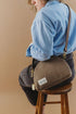 Rear side view of Hopper bag worn crossbody with a blue shirt