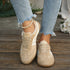 Front view of beige retro sneakers worn with jeans