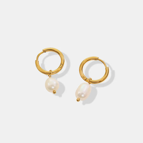 Pair of gold-plated hoops with freshwater pearl drops on white