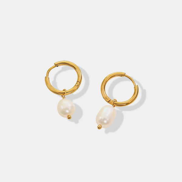 Pair of gold-plated hoops with freshwater pearl drops on white