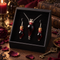 Handmade red blood vial necklace and matching drop earrings displayed in a black presentation box; box not included