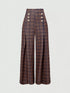 Front view of brown plaid trousers with decorative button rows on white