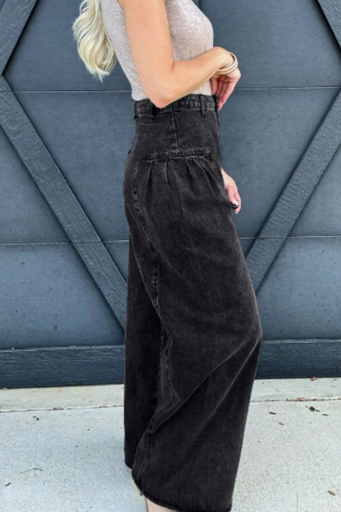 Side view of black high-rise wide-leg jeans with a tucked-in gray top