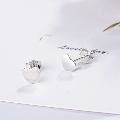 925 sterling silver heart stud earrings on a white card with butterfly backs visible