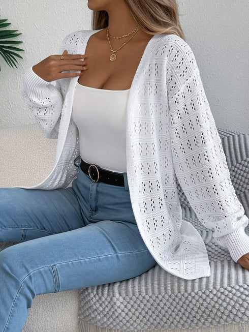 White crochet-knit cardigan, seated view with the open front visible