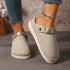 Beige slip-on clogs worn on a model, front angled view