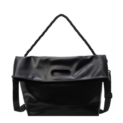 Black foldover hobo bag with braided shoulder strap on white background