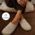 Beige Fulton house shoes worn while seated, close-up of the wool uppers