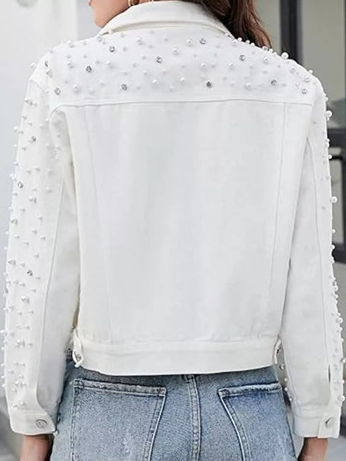 Back view of white jacket showing shoulder and sleeve embellishments