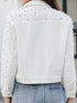 Back view of white jacket showing shoulder and sleeve embellishments