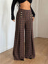 Brown plaid wide-leg pants worn with a black crop top