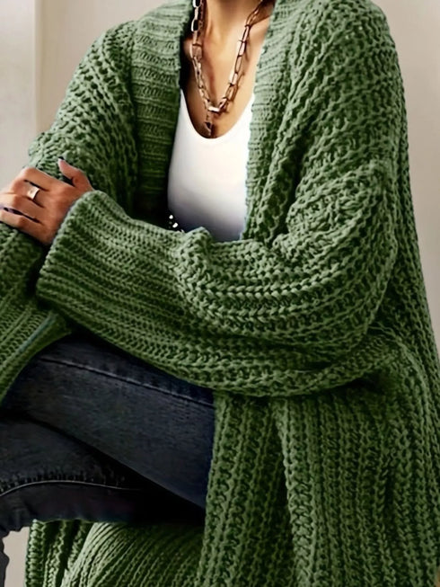 Green longline cardigan showing wide ribbed sleeve cuffs