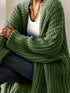 Green longline cardigan showing wide ribbed sleeve cuffs
