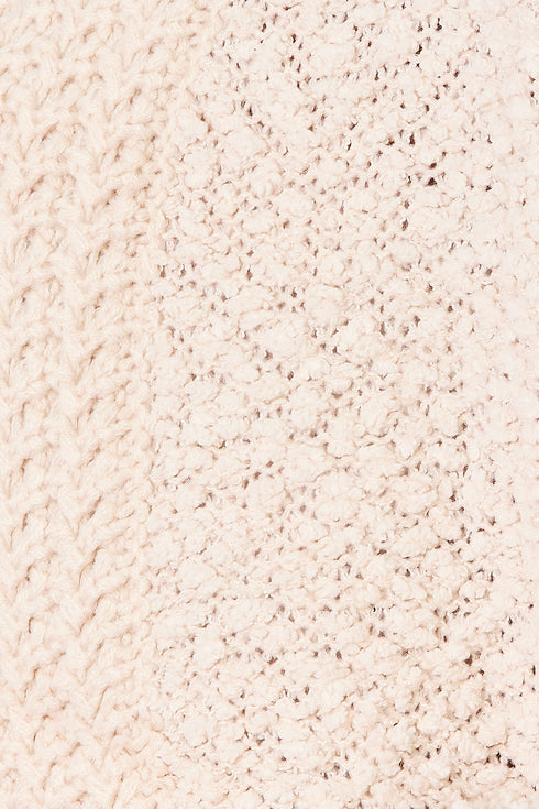 Close-up of cream cardigan's textured acrylic knit