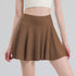 Coffee brown pleated tennis skort front view on model